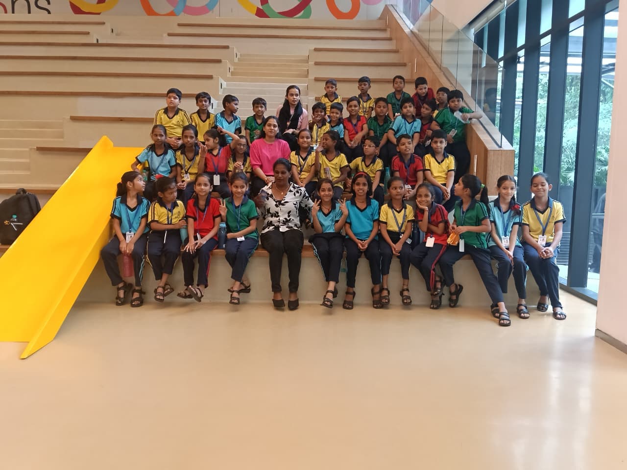 Students and teachers seated together during a picnic outing